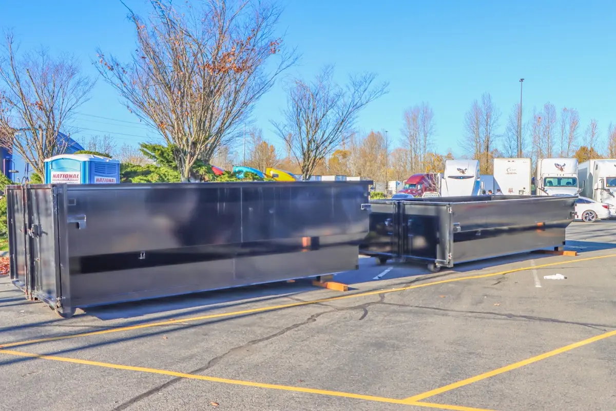 Professional dumpster rental service with roll-off container on residential driveway in Cherry Valley